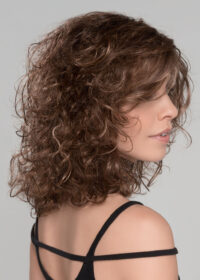 The Storyville is a shoulder length style with bouncy curls all over.